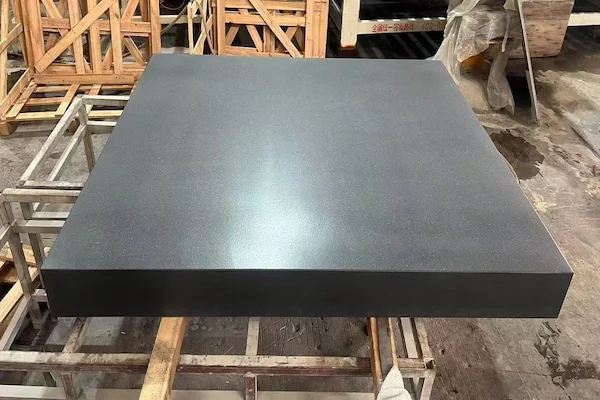 Absolute Black Granite rectangular plinth on timber supports in a supplied factory quality-review image