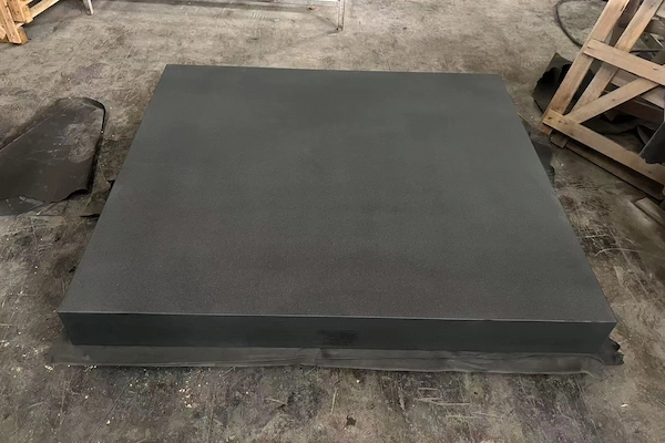 Absolute Black Granite plinth stacked for surface inspection in a supplied factory image