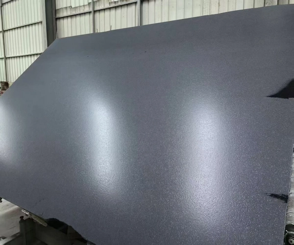 Leathered Absolute Black Granite slab surface shown in a supplied factory stock image