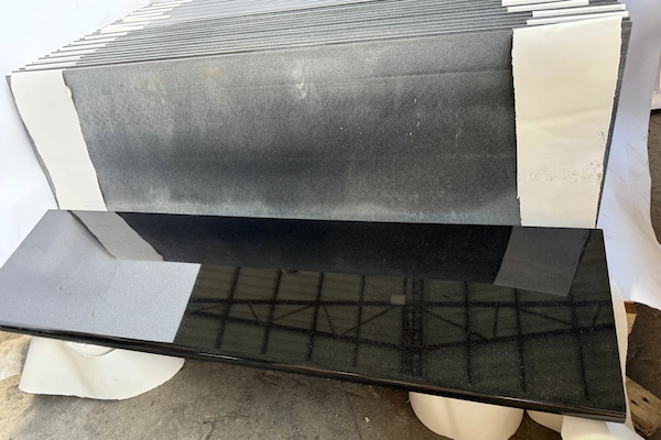 Polished Absolute Black Granite countertop component in a supplied factory prefabrication reference