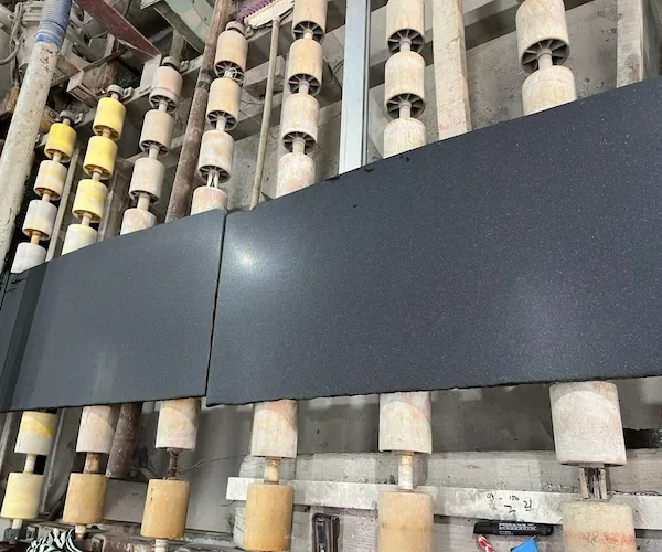 Honed-finish Absolute Black Granite slab on a roller table in a supplied factory stock reference