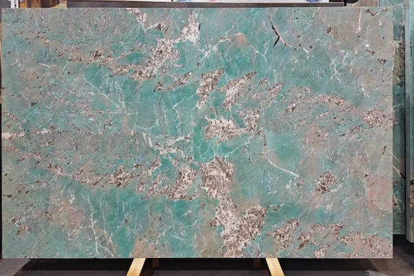 Polished Amazon Green Quartzite surface showing turquoise-green colour variation and pale mineral areas