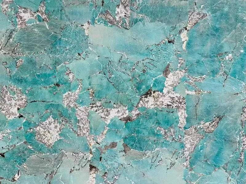 Amazon Green Quartzite slab surface with turquoise blue-green movement, pale mineral areas and charcoal-grey variation