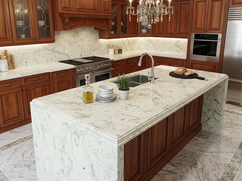 Andromeda White Granite Kitchen Top in a supplied kitchen application image, showing a warm white granite field with soft grey mineral movement