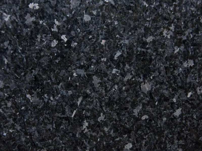 Angola Black Granite slab surface with deep-black and silver-grey crystalline mineral movement
