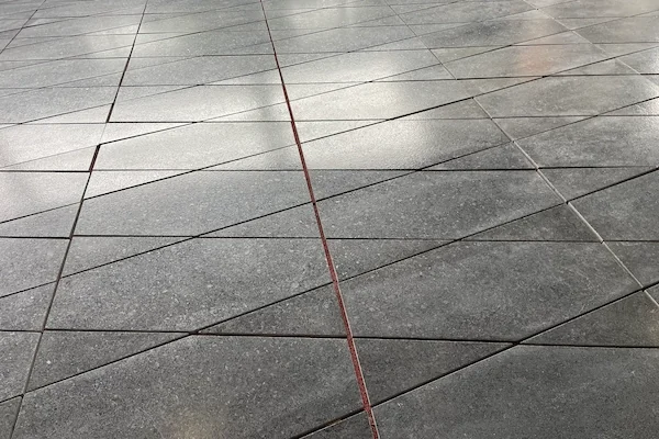 Angola Black Granite surface processing shown in a supplied workshop image