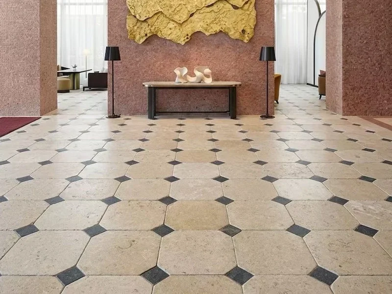 Beige Limestone Floor Tile shown in a supplied interior application with beige field tiles and dark accent insets