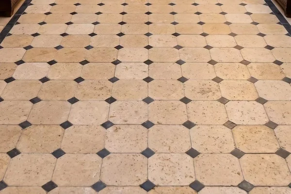 Beige Limestone Floor Tile close view of light limestone field tiles and darker accent insets