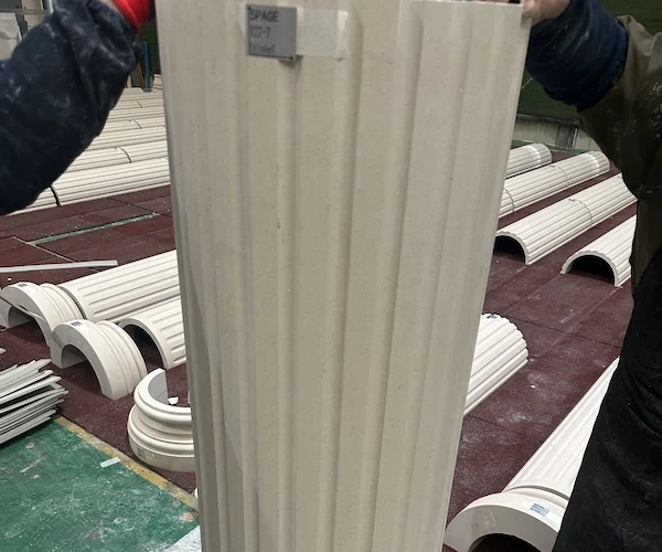 Beige Limestone fluted shaft segment held upright for component alignment review