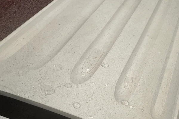 Close view of a Beige Limestone fluted column shaft surface during workshop inspection