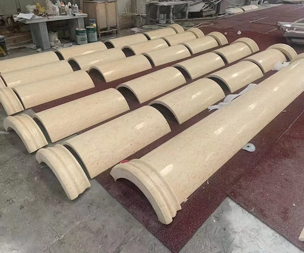Beige Marble column shaft components dry-laid on a factory floor for visual review