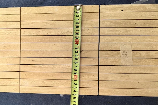 Beige Travertine Linear Mosaic pieces shown in a supplied factory tone sorting reference image