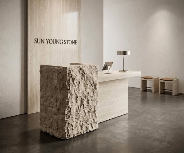 3D visualization of a beige split-face stone reception desk in an entry concept