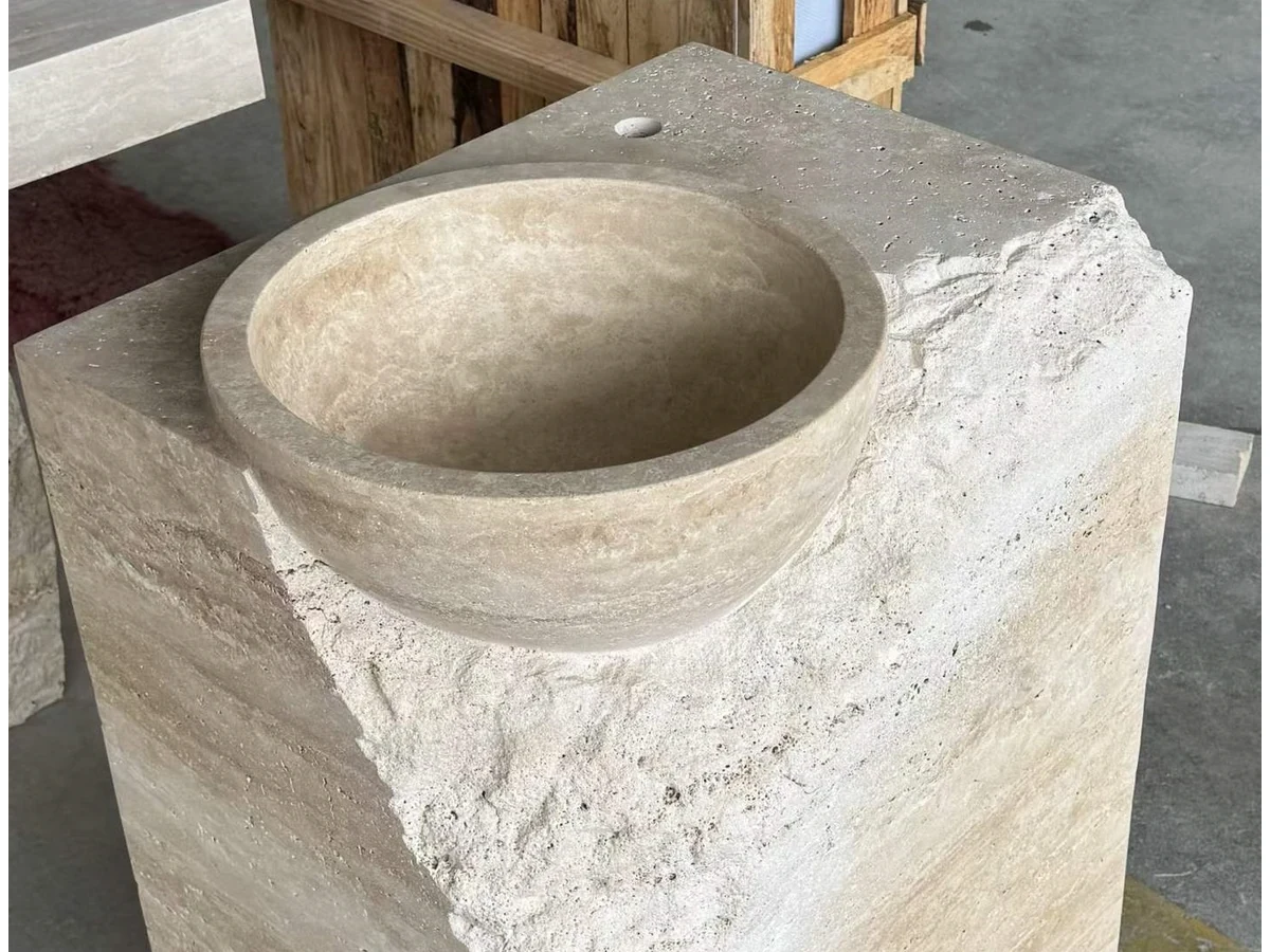 Beige travertine basin cavity prepared during split-face vanity fabrication