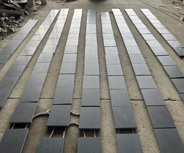 G684 Black Basalt flooring tiles arranged in rows for factory dry-lay inspection