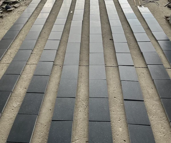 Dark grey basalt tiles arranged for factory color-matching dry lay