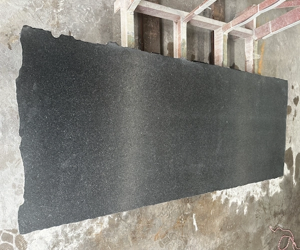 Leathered Black Galaxy Granite slab surface shown in a supplied material reference
