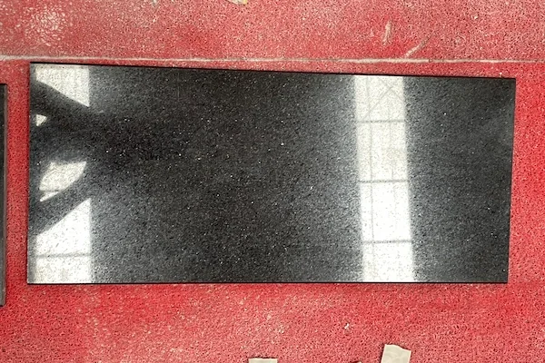 Polished Black Galaxy Granite tile surface shown in a supplied workshop reference