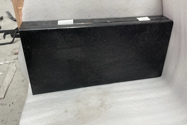 Polished Black Galaxy Granite tiles prepared for packing in a supplied production image