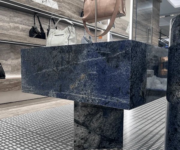 3D visualization of a blue sodalite quartzite reception desk in a luxury retail concept