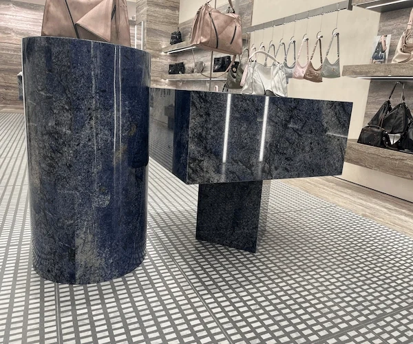 3D visualization of a blue natural-stone display desk in a contemporary showroom concept