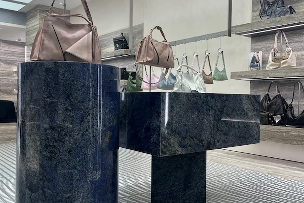 Blue sodalite quartzite reception desk with matching stone display elements shown from the front