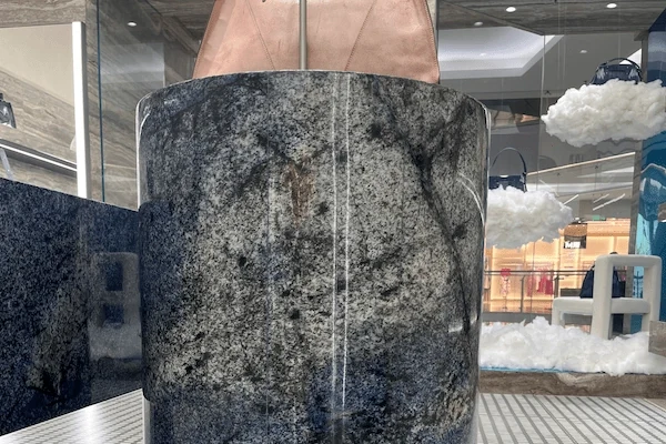 Close view of blue sodalite quartzite reception desk stone surfaces and stepped counter geometry