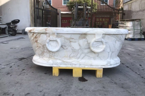 Supplied freestanding white-and-gold marble bathtub reference for Calacatta Gold custom design discussion