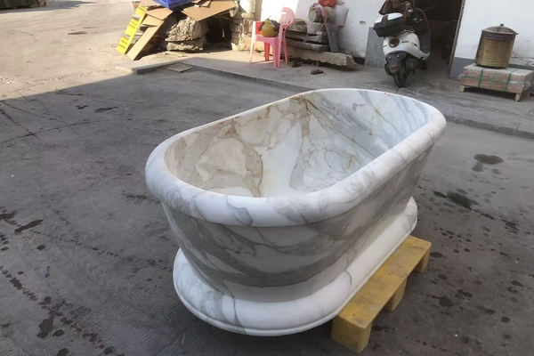 Calacatta Gold marble bathtub carving detail in a supplied workshop inspection reference