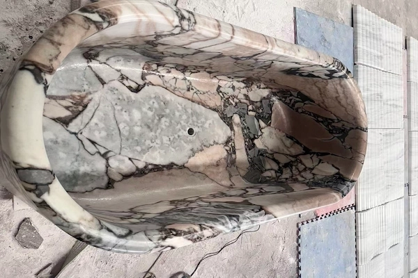 Supplied overhead workshop reference showing the carved interior and drain opening of a Calacatta Viola marble bathtub