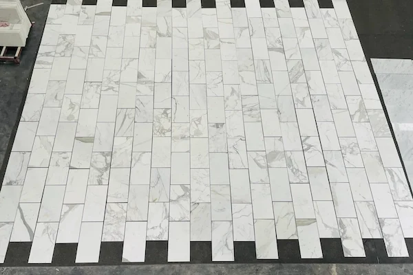 Calacatta White Marble Mosaic Tile linear mosaic layout board shown in a supplied polished surface review image