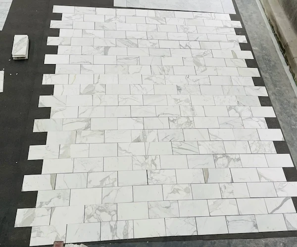 Calacatta White Marble Mosaic Tile white veined mosaic pieces aligned in a supplied pattern review image