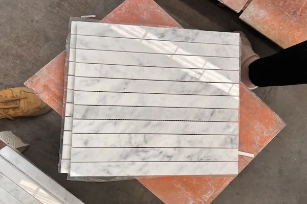 Carrara White Linear Strip Marble Mosaic module arrangement shown in a supplied linear sheet dry-lay image