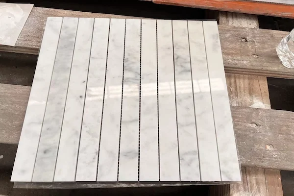 Carrara White Linear Strip Marble Mosaic pattern modules shown in a supplied shade grading review image