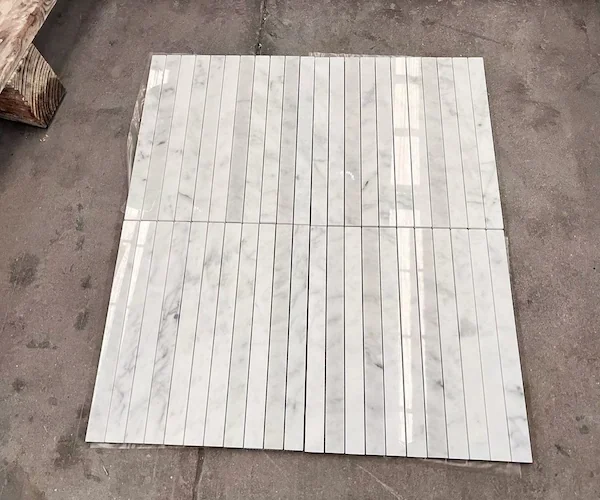 Carrara White Linear Strip Marble Mosaic modules shown in a supplied mesh-backed sheet reference image