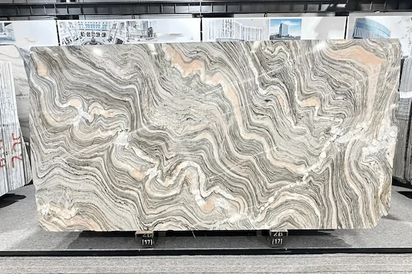 Polished Cipollino Marble slab in a factory review setting with wavy charcoal mineral movement