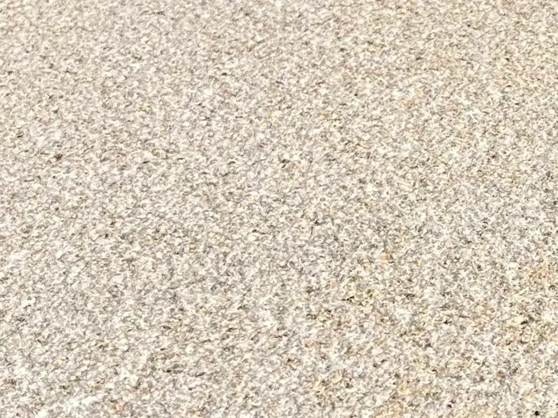 G606 Light Rusty Granite surface with fine warm-grey and rusty-beige mineral speckles