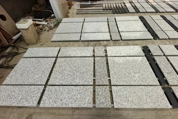 G623 Grey Granite tiles arranged for dry-lay review in a supplied workshop image