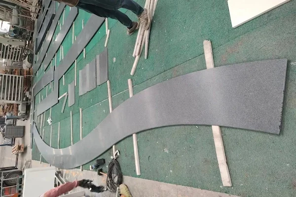 G654 Dark Grey Granite curved fabricated component shown in a supplied workshop image