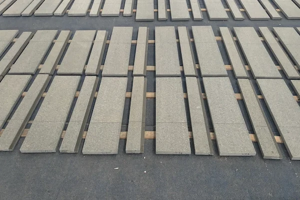 G654 Dark Grey Granite sandblasted tiles shown in a supplied surface-review image