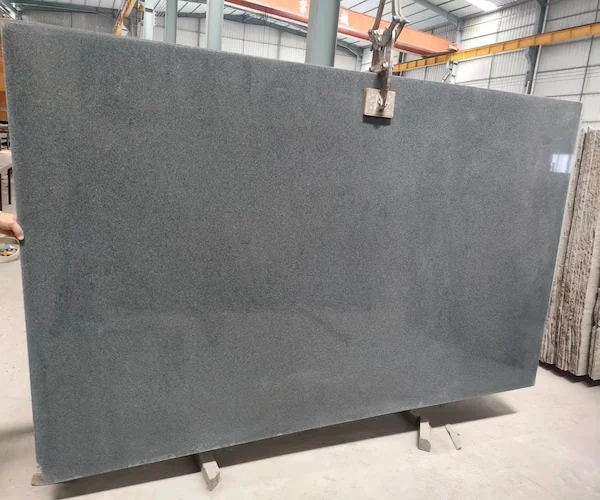 G654 Dark Grey Granite polished slab shown in a supplied inspection reference