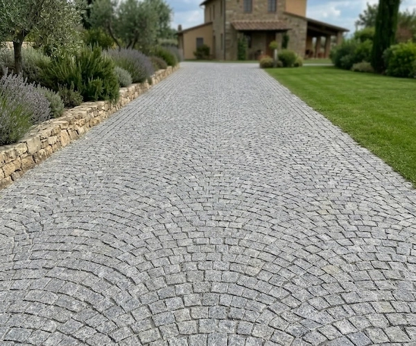 3D visualization of G654 Granite Cube Stone in a curved fan-pattern residential driveway concept