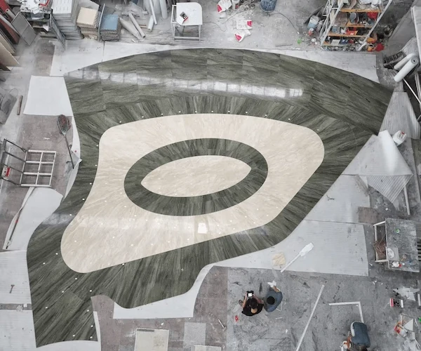 Overhead factory layout reference for a curved Green Granite waterjet pattern with light stone inlay