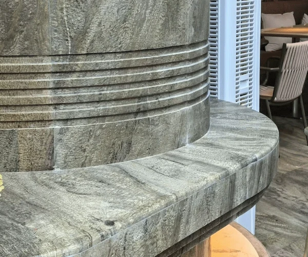 Curved Green Granite stone element with stepped profile shown as a fabrication and application detail