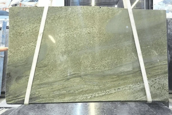 Polished Green Granite slab secured for inspection, showing an olive-green field and soft horizontal movement