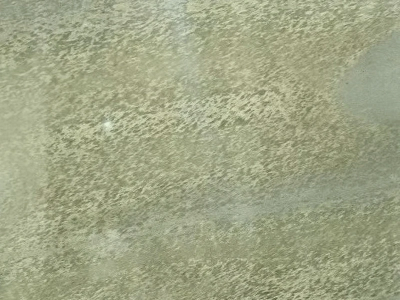 Green Granite slab surface with muted olive-green colour and directional grey mineral movement