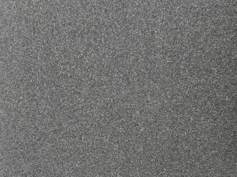 Grey Granite slab surface with a fine medium-grey speckled pattern