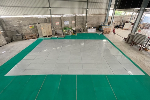 Polished Grey Granite wall tiles arranged for dry-lay review in the workshop