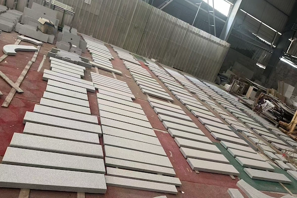 Flamed Grey Granite pool coping pieces arranged for dry-lay inspection