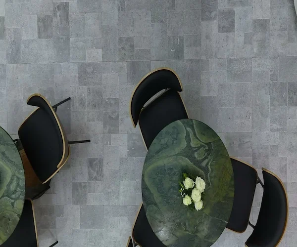 Grey Limestone French Pattern Tile installed floor pattern shown beneath dining furniture in a supplied reference image